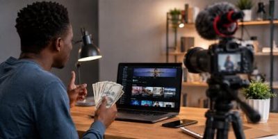 Créateur de contenu filme une vidéo devant son ordinateur dans un studio à domicile